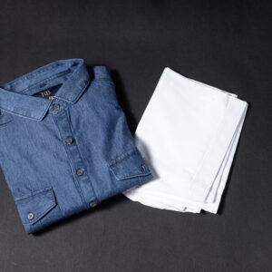 Folded denim Pathani kurta paired with a crisp white pajama, displayed on a dark background for a clean and stylish presentation.