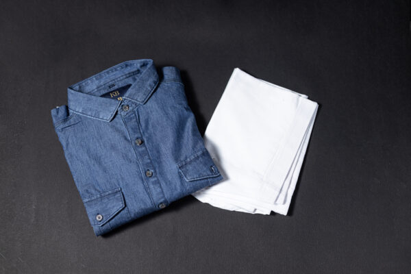 Folded denim Pathani kurta paired with a crisp white pajama, displayed on a dark background for a clean and stylish presentation.